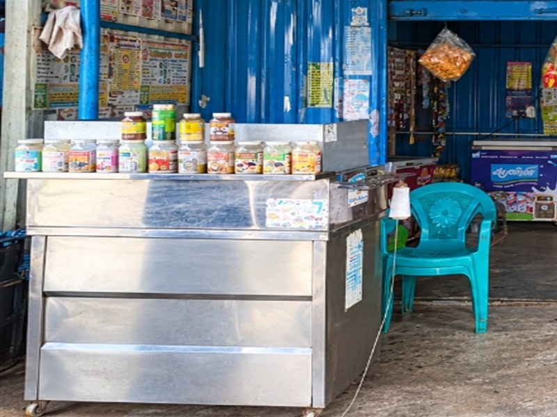 Main stainless steel service counter photograph at Aavin milk booth Naidumangalam.